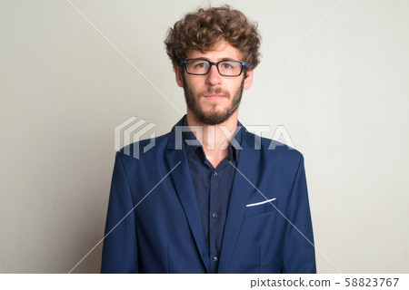 Face of young bearded businessman with eyeglasses in suit 58823767