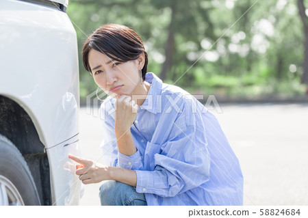 Young woman driving accident suicide rub scratching wound 58824684