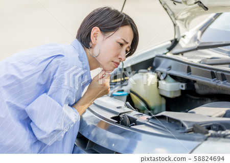 Young woman Car engine failure check Pre-run check Maintenance 58824694