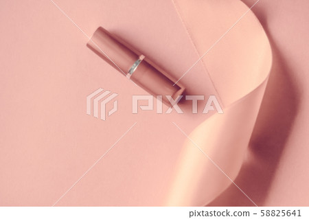 Luxury lipstick and silk ribbon on blush pink 58825641