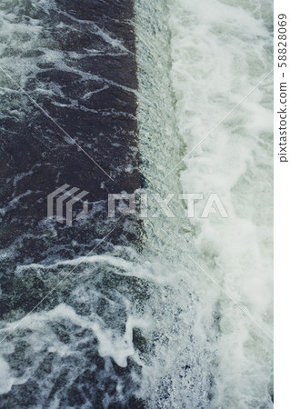 rapid flow of water close-up rapid flow of water close-up 58828069