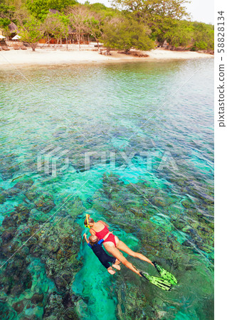 Mother, kid in snorkeling mask dive underwater Mother, kid in snorkeling mask dive underwater 58828134