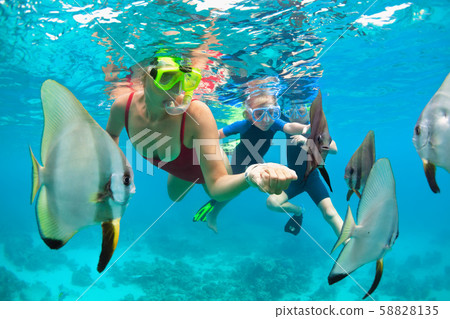 Mother, kid in snorkeling mask dive underwater Mother, kid in snorkeling mask dive underwater 58828135