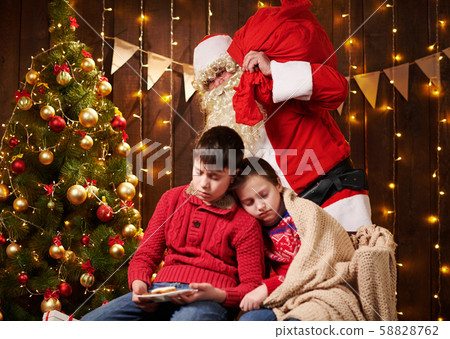 The children waited a long time for Santa, now The children waited a long time for Santa, now 58828762