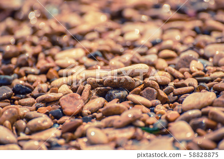 Sea pebble background 58828875