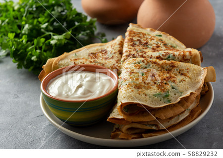 Savory pancakes (crepes) with parsley. Savory pancakes (crepes) with parsley. 58829232