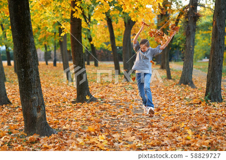 Girl having holiday in autumn city park, running, Girl having holiday in autumn city park, running, 58829727