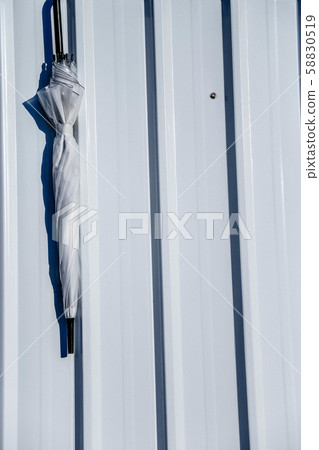 White wall with white umbrella 58830519