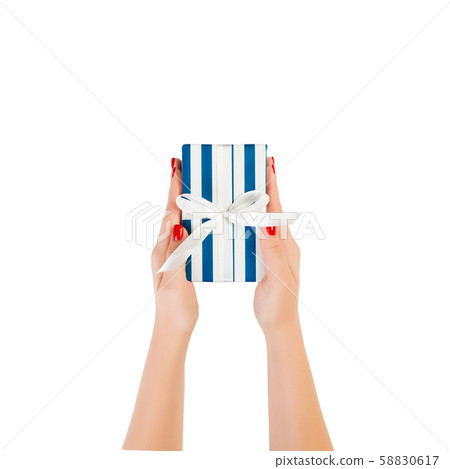 Woman hands give wrapped Christmas or other 58830617