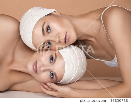 Portrait of beautiful young women isolated on brown studio background Portrait of beautiful young women isolated on brown studio background 58830788