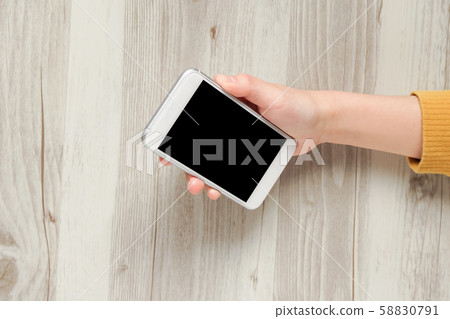Female hand using smartphone Female hand using smartphone 58830791