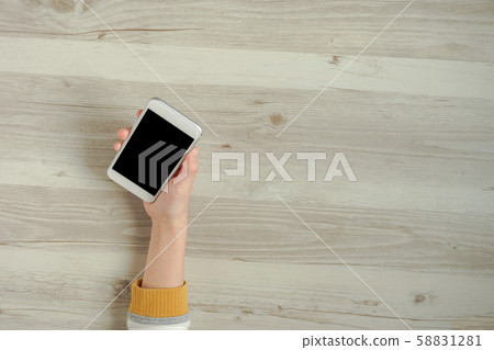 Female hand using smartphone and copy space Female hand using smartphone and copy space 58831281