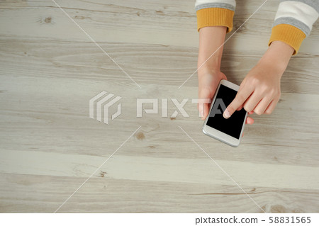Female hand using smartphone and copy space Female hand using smartphone and copy space 58831565