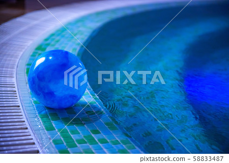 Blue ball in shallow blue and green swimming pool 58833487