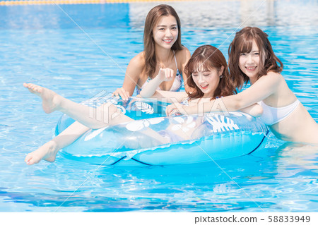 Woman enjoying in the pool Woman enjoying in the pool 58833949