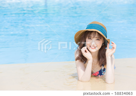 Woman lying on the poolside Woman lying on the poolside 58834063