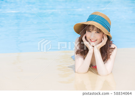 Woman lying on the poolside Woman lying on the poolside 58834064
