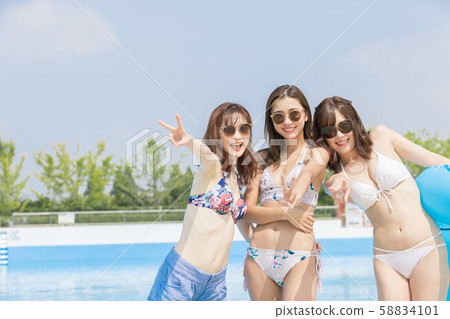 Woman enjoying in the pool Woman enjoying in the pool 58834101