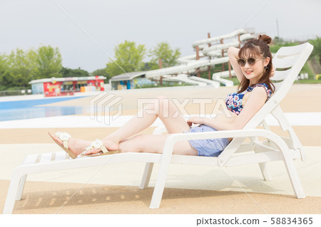 Woman enjoying in the pool Woman enjoying in the pool 58834365