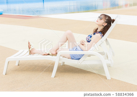 Woman enjoying in the pool Woman enjoying in the pool 58834366