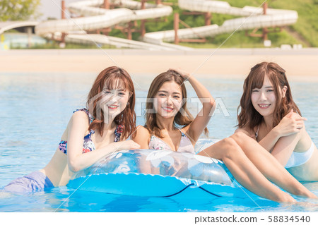 Woman enjoying in the pool Woman enjoying in the pool 58834540