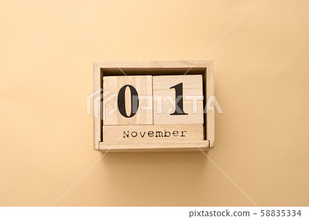 November 1st. Day 1 of November set on wooden calendar on on beige background November 1st. Day 1 of November set on wooden calendar on on beige background 58835334