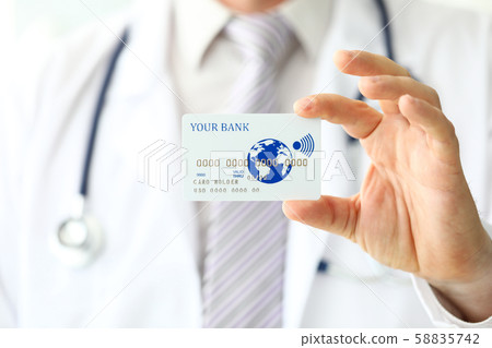 Male GP holding banking card in arm Male GP holding banking card in arm 58835742