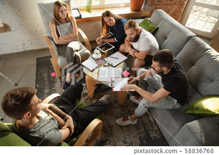 Group of young caucasian office workers have creative meeting to discuss new ideas Group of young caucasian office workers have creative meeting to discuss new ideas 58836768