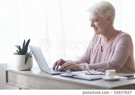 Professional business woman typing email to client 58837687