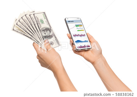 Trading app opened on smartphone and cash in female hands 58838162