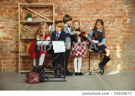 Group of kids spending time after school together. Handsome friends resting after classes. 58839673