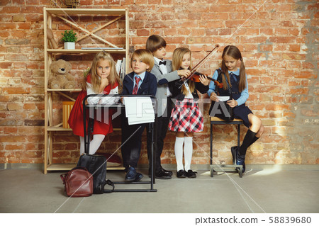 Group of kids spending time after school together. Handsome friends resting after classes. Group of kids spending time after school together. Handsome friends resting after classes. 58839680
