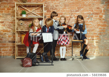 Group of kids spending time after school together. Handsome friends resting after classes. Group of kids spending time after school together. Handsome friends resting after classes. 58839686