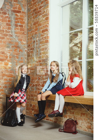 Group of kids spending time after school together. Handsome friends resting after classes. Group of kids spending time after school together. Handsome friends resting after classes. 58839714