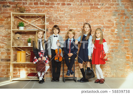 Group of kids spending time after school together. Handsome friends resting after classes. Group of kids spending time after school together. Handsome friends resting after classes. 58839738
