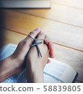 Cross on praying hand of Women faith jesus promise 58839805