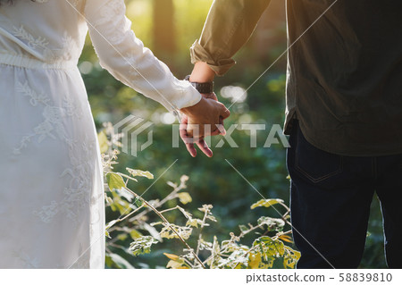 Sweetheart holding hand back lady man love bonding Sweetheart holding hand back lady man love bonding 58839810
