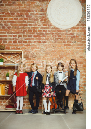 Group of kids spending time after school together. Handsome friends resting after classes. Group of kids spending time after school together. Handsome friends resting after classes. 58839862