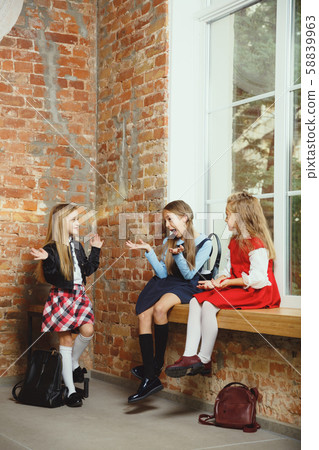 Group of kids spending time after school together. Handsome friends resting after classes. Group of kids spending time after school together. Handsome friends resting after classes. 58839963