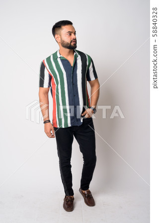 Full body shot of young bearded Indian man thinking 58840328