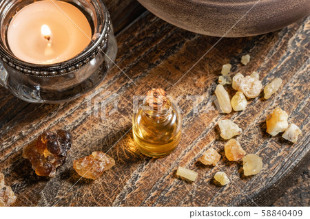 A bottle of frankincense essential oil with frankincense resin A bottle of frankincense essential oil with frankincense resin 58840409