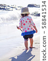 Toddler playing on the shore 58841534