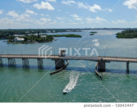 Aerial view of street bridge crossing ocean Aerial view of street bridge crossing ocean 58843447