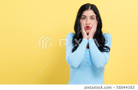 Surprised young woman posing 58844383