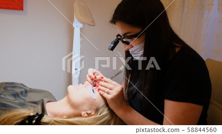 Woman Eye with Long Eyelashes. Eyelash Extension Woman Eye with Long Eyelashes. Eyelash Extension 58844560