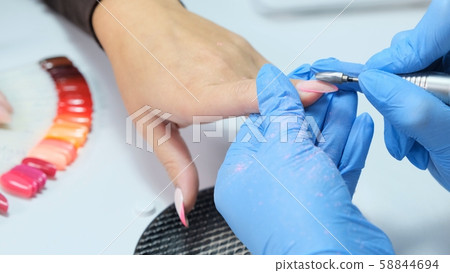 Close up. Electric Nail Drill in Manicure Salon. Hardware manicure in a beauty salon. Female 58844694