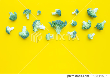 Fresh broccoli on yellow background. Fresh broccoli on yellow background. 58844896