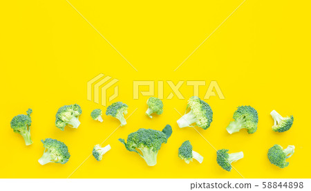 Fresh broccoli on yellow background. 58844898