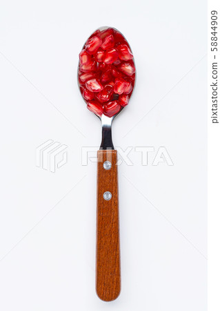 Spoon with pomegranate seeds isolated on white 58844909