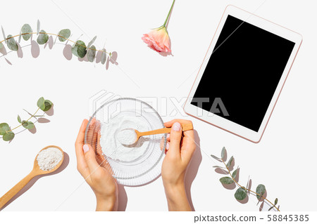 Woman's hands holding bowl with clay powder Woman's hands holding bowl with clay powder 58845385